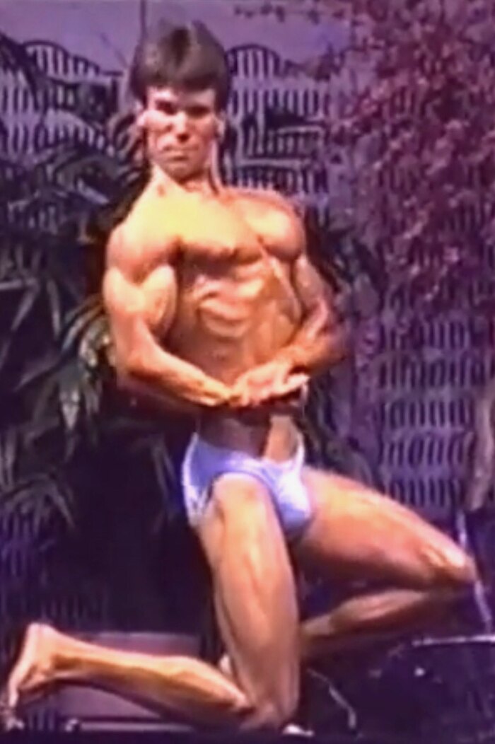 Dr. David Waring in a muscular competition pose during his NPC Mr. Michigan bodybuilding career